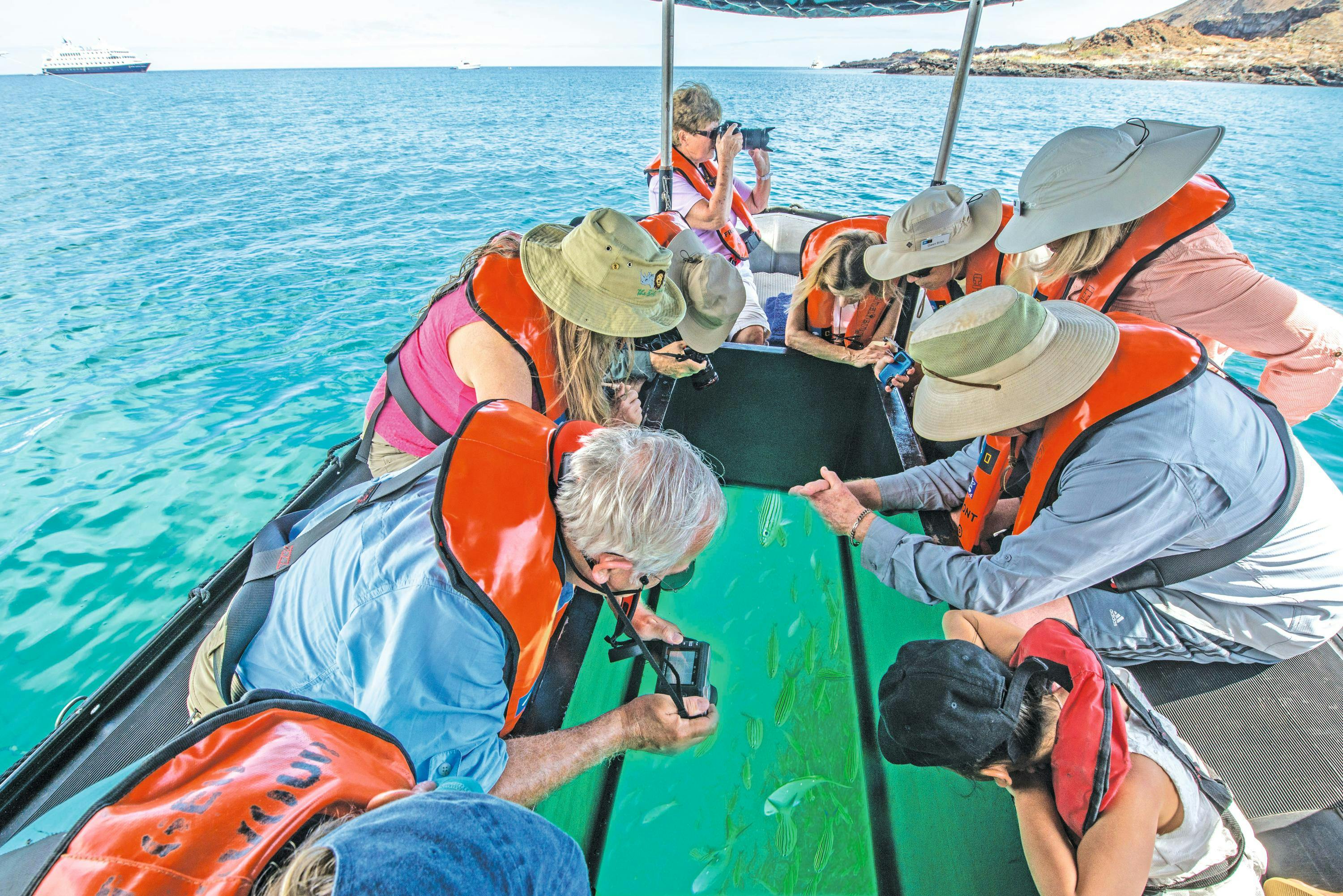 Guests on a glass bottom zodiac explore from the ship National Geographic Endeavour II in the Galapagos Islands, Ecuador.